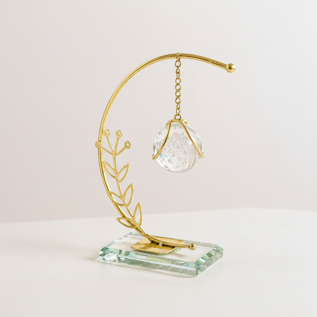 Golden Metallic Semicircle Frame on Glass Platform with Leaves and Hanging Crystal Ball inside