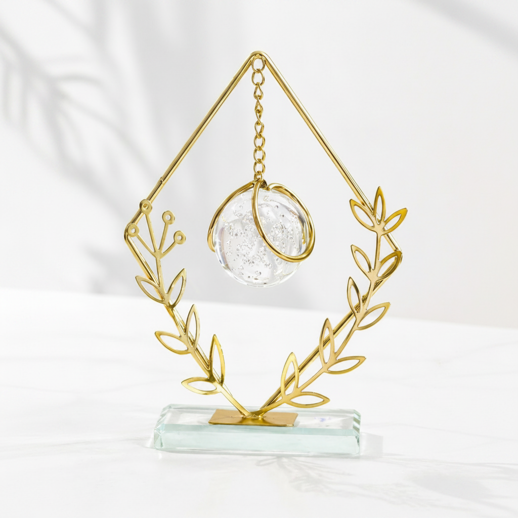 Golden Metallic Diamond Shaped Frame on Glass Platform with Leaves and Hanging Crystal Ball inside