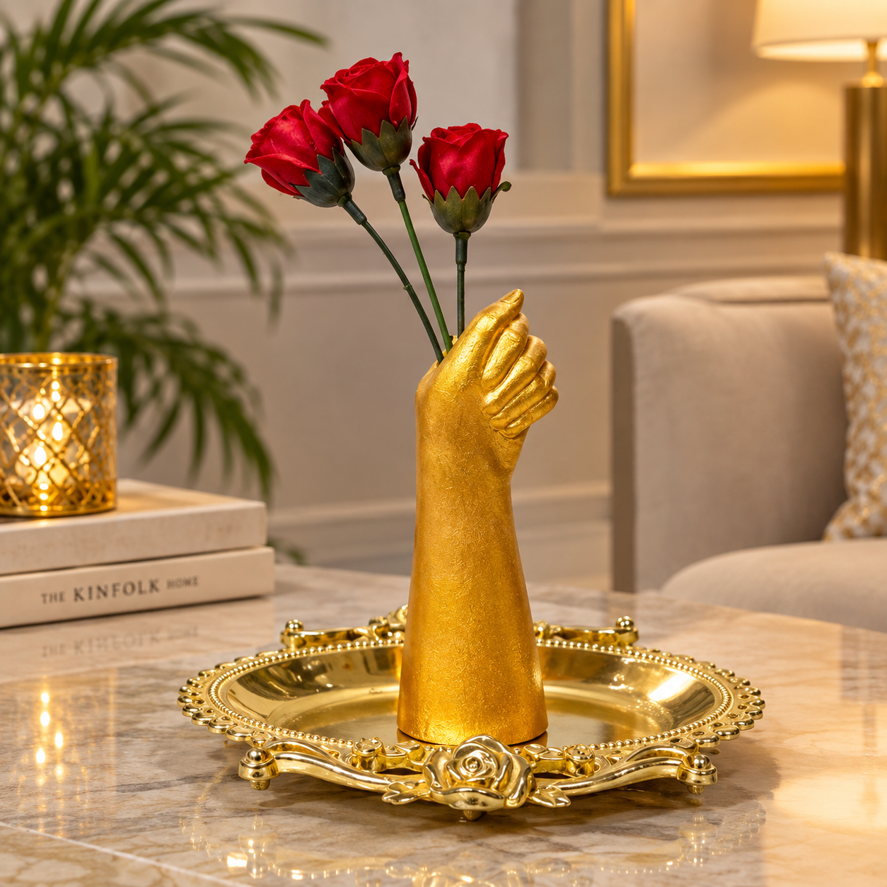 Gold Painted Hand Sculpture Vase holding three red flowers placed in a Golden tray