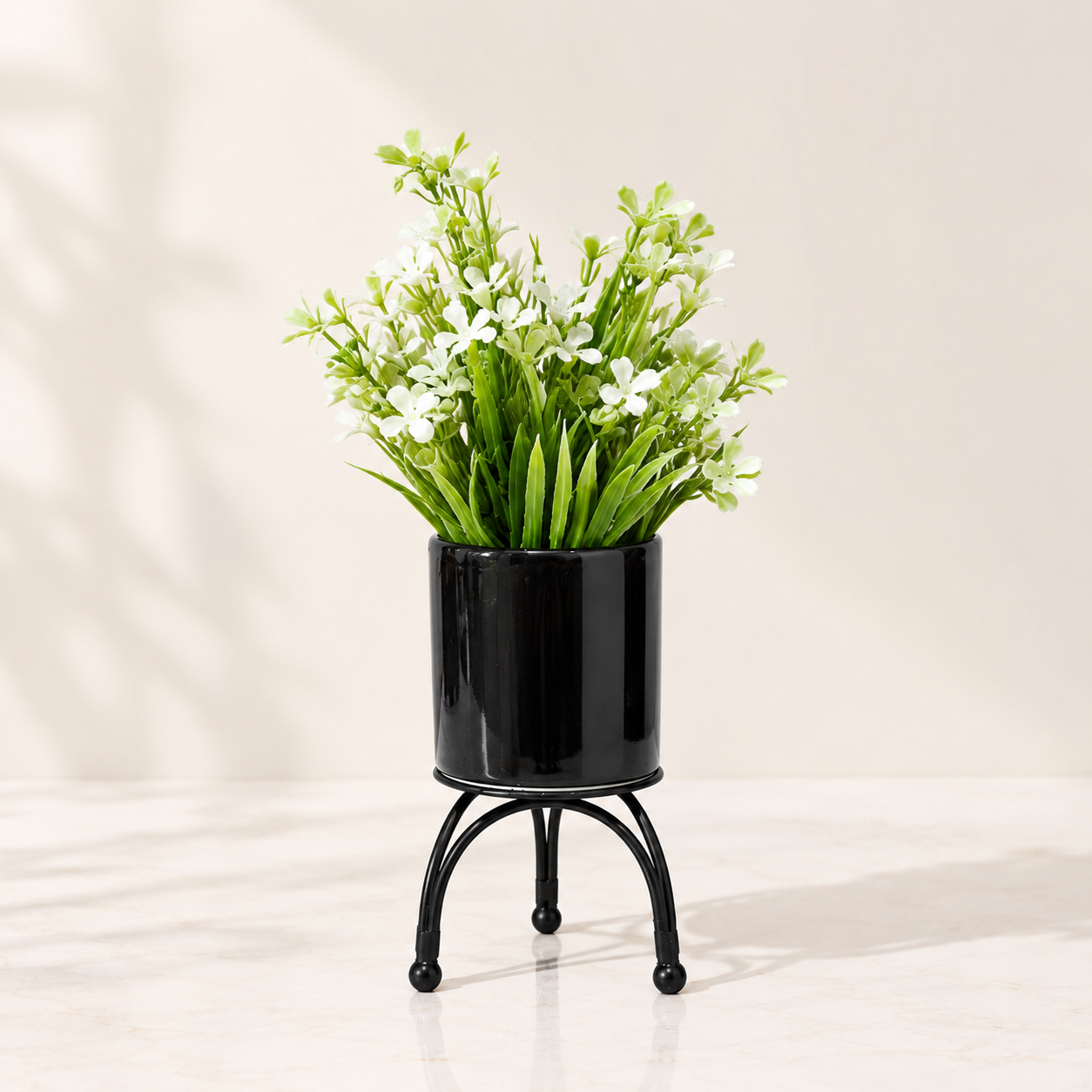 Black Ceramic Pot with Artificial White Flowers Plant on Black Curved Legs Metallic Stand