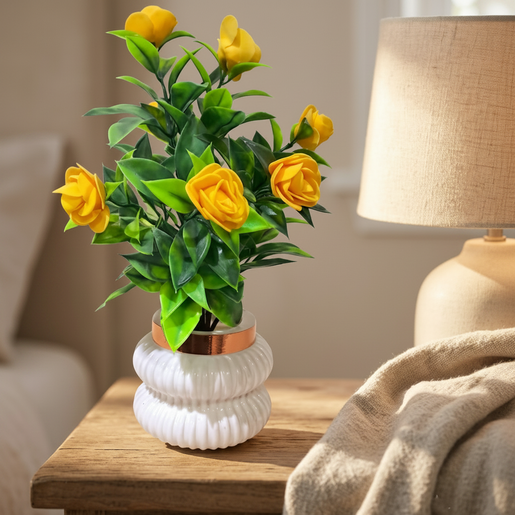 Yellow Camellia-Style Blossoms and lush green foliage in a white, ribbed Plastic Pot