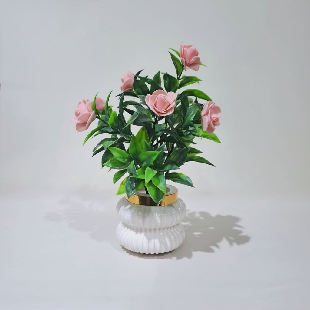 Peach Camellia-Style Blossoms and lush green foliage in a white, ribbed Plastic Pot