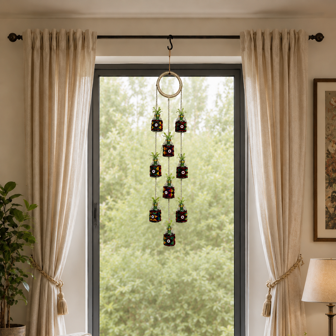 Handmade vertical hanging decoration made of recycled mini glass bottles and golden rope.