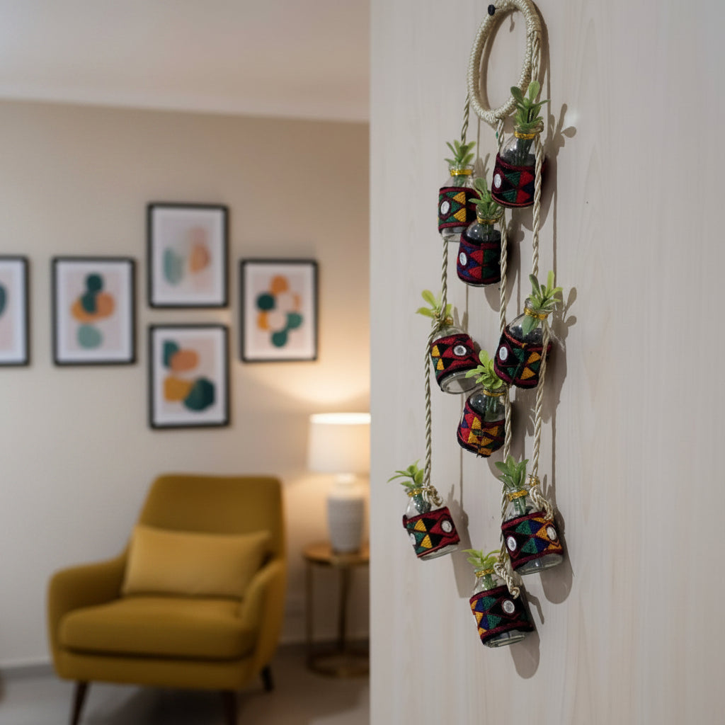 Handmade vertical hanging decoration made of recycled mini glass bottles and golden rope.