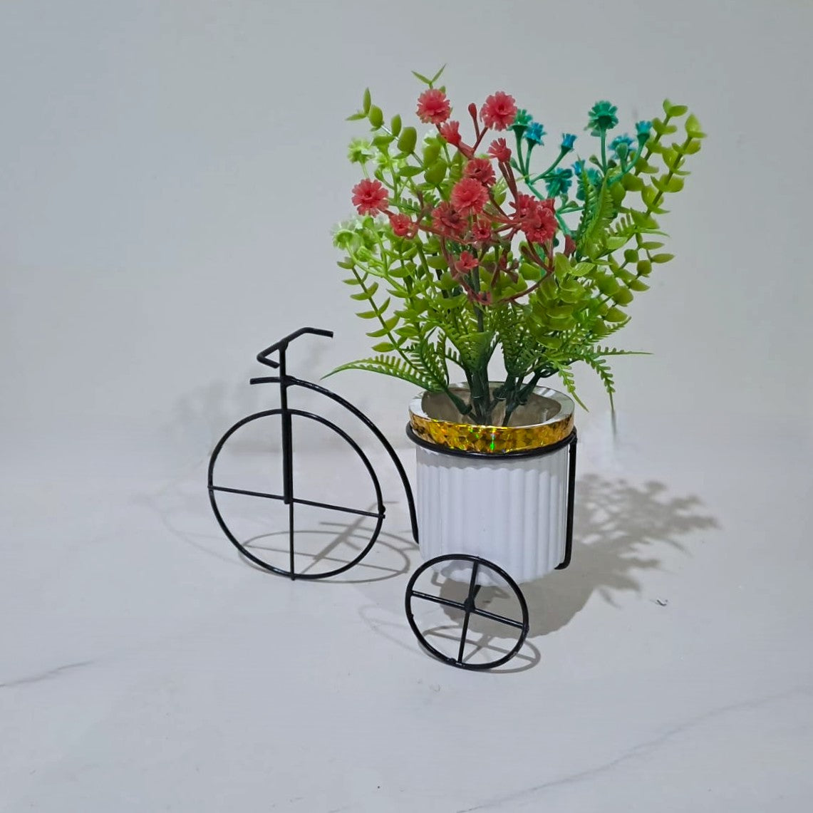 Black Metallic Tricycle with a White Plastic Planter filled with multi colour Gypsophila Flowers