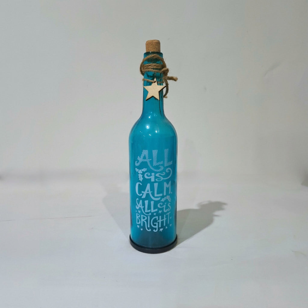 Blue Glass Bottle with printed “All is Calm - All is Bright” with LED Starry String Lights inside