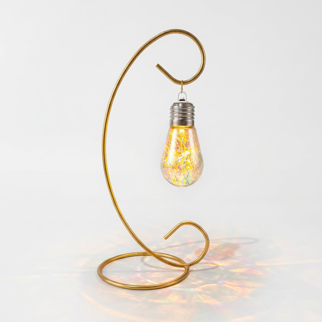 An elegant LED Bulb filled with light-reflecting filaments hanged on a golden curved metal stand