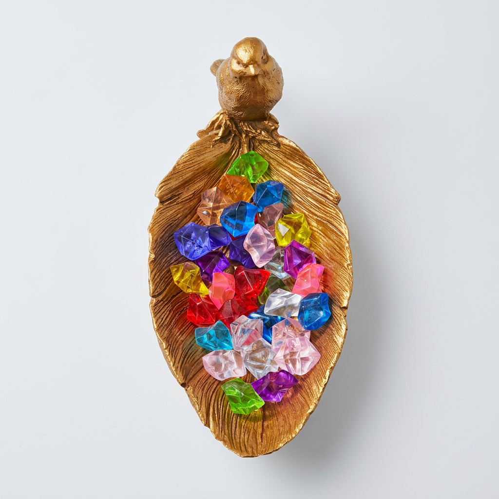 Golden Resin decorative leaf shaped tray with a small golden sparrow perched on the side, filled with colorful faux Crystal Gems