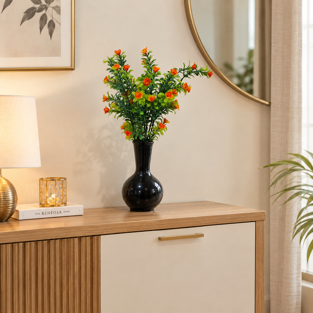 Black Ceramic Pot with a Bunch of Plastic Plant leaves & Orange flowers